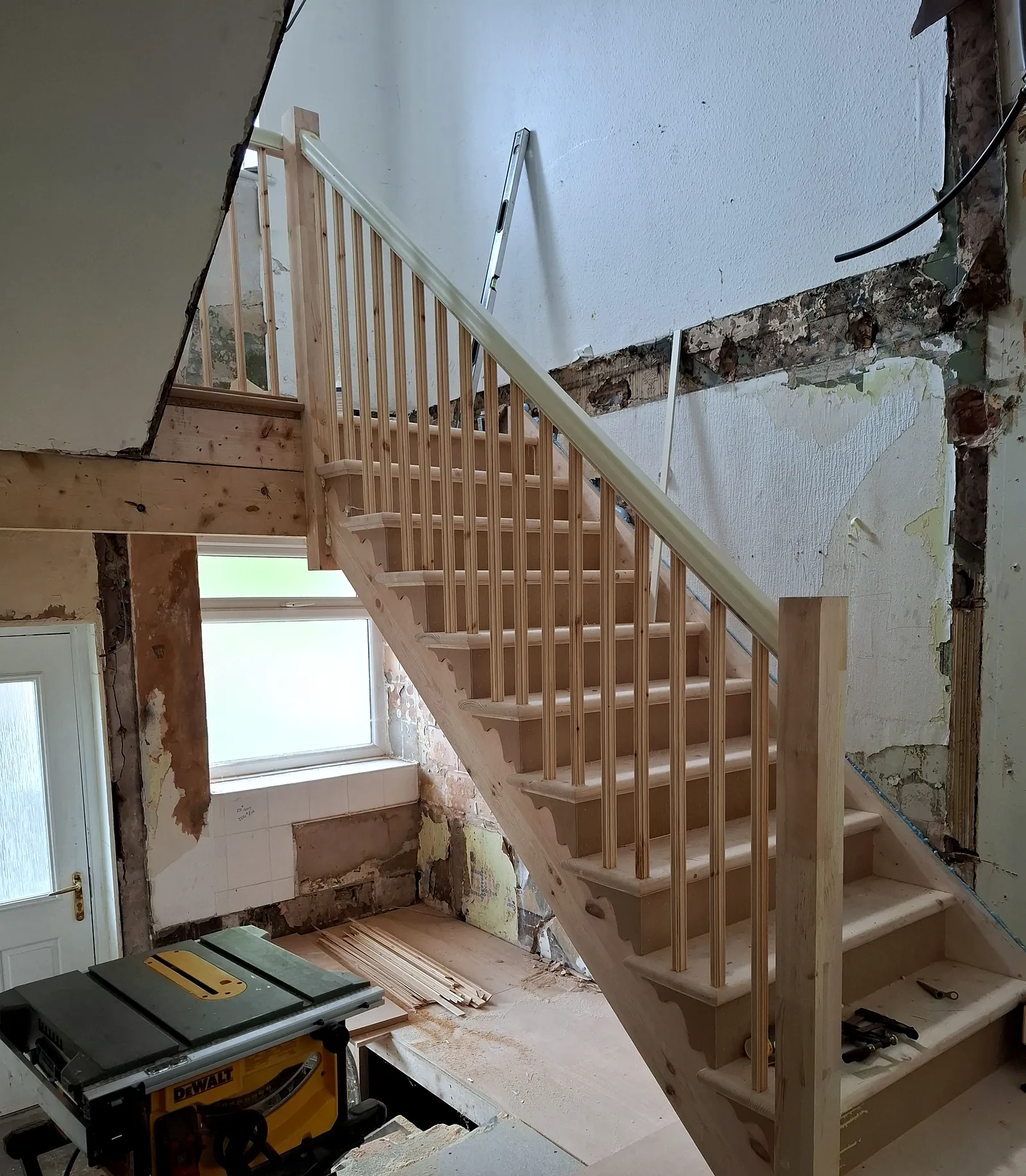 New pine staircase with spindles and handrail built on site during a house renovation